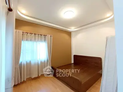 Spacious bedroom with elegant wooden bed and soft lighting