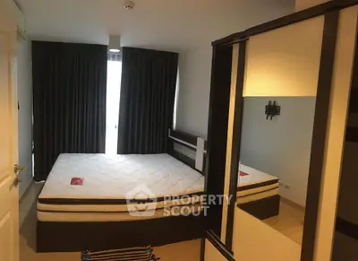 Spacious bedroom with large bed and modern wardrobe in a cozy apartment.