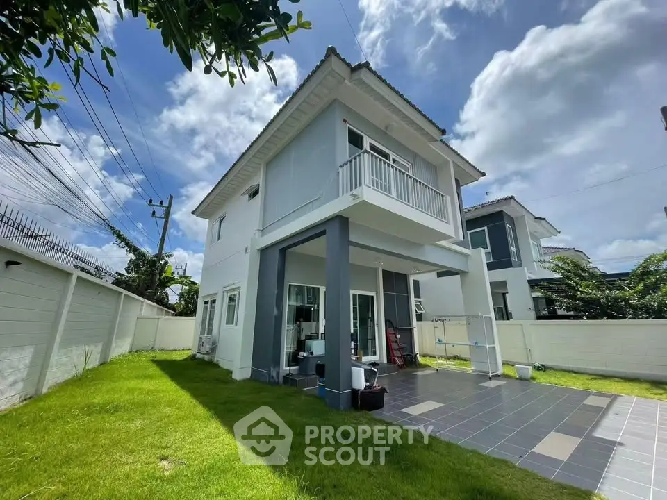 Modern two-story house with spacious backyard and patio, perfect for family living.