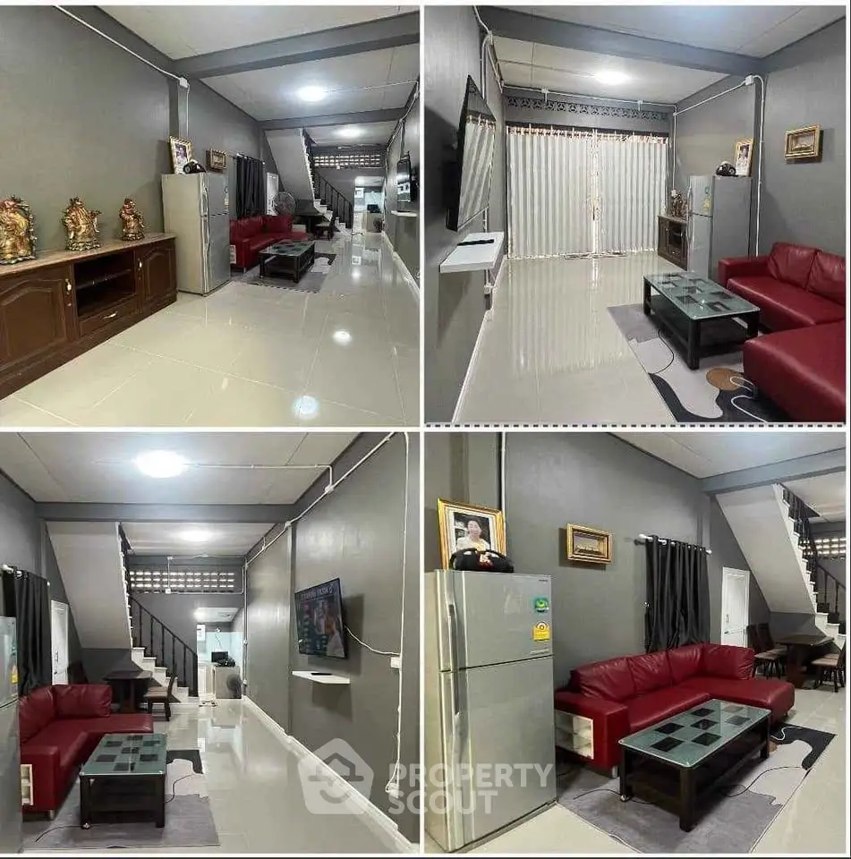 Spacious living room with modern decor, red sofas, and sleek glass coffee table in a stylish home.