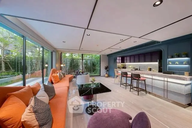 Luxurious open-plan living room with modern kitchen and garden view