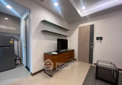 Modern living room with sleek furniture and open kitchen view