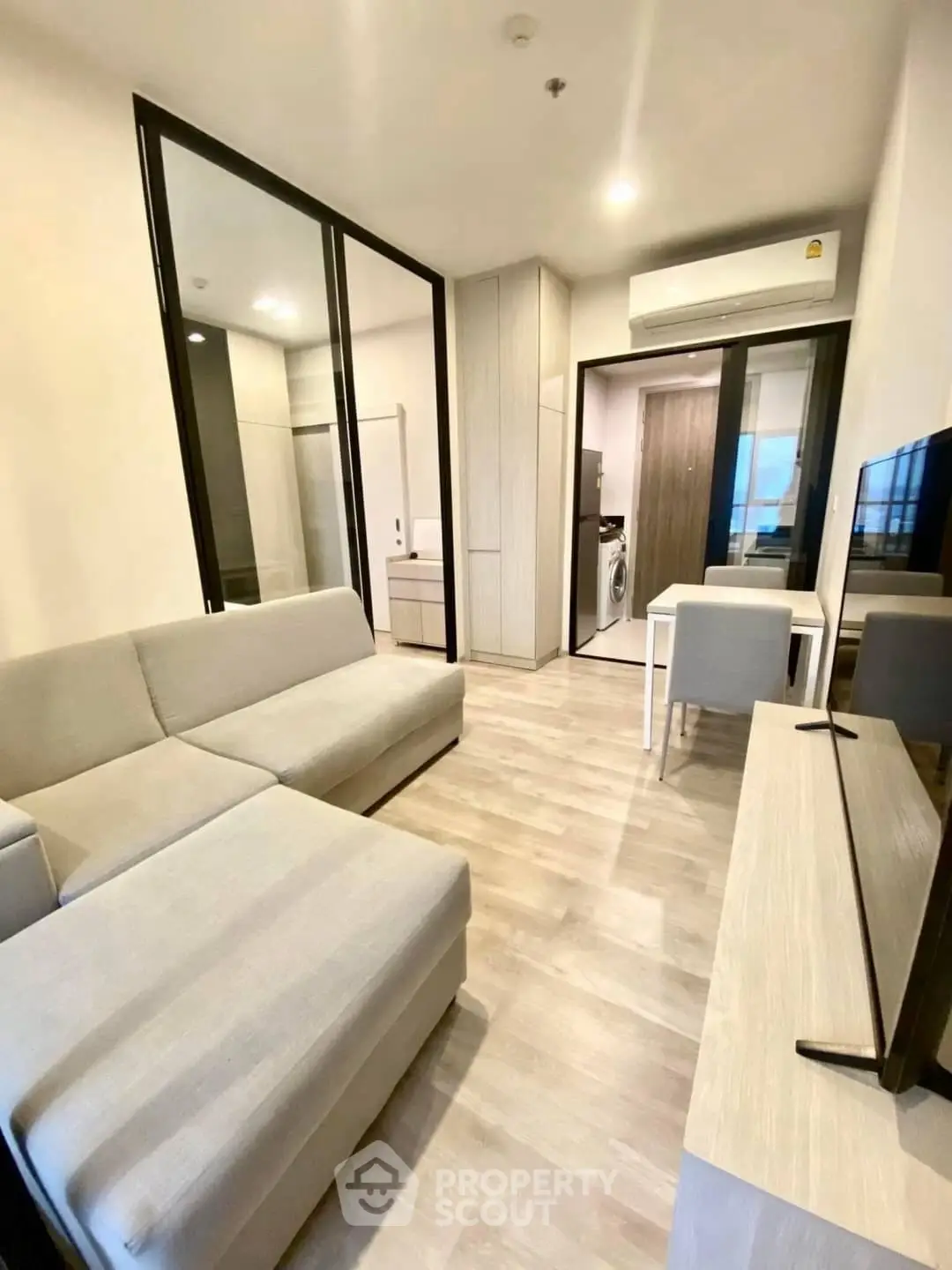 Modern living room with sleek furniture and open layout in a stylish apartment.