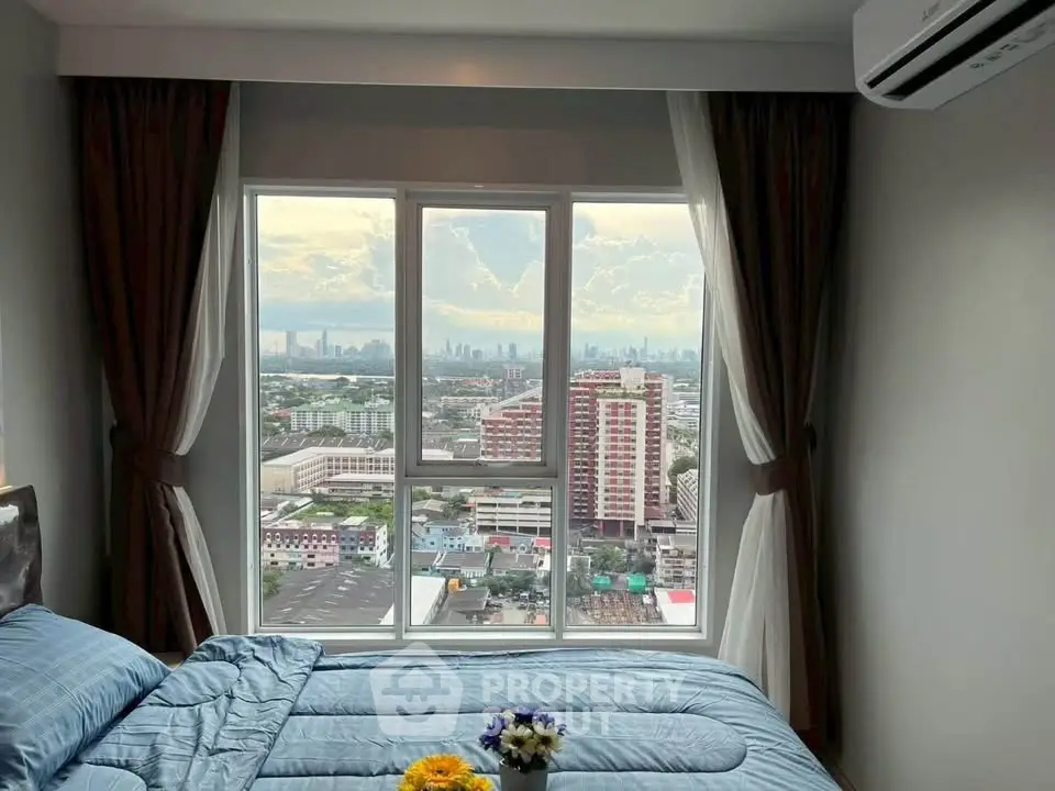 Stunning bedroom with panoramic city view from large window, featuring cozy bedding and elegant curtains.