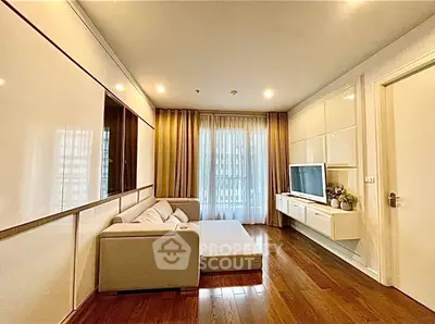 Modern living room with sleek design, cozy sofa, and large window for natural light.