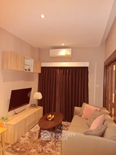 Cozy living room with modern decor and plush seating, perfect for relaxation.
