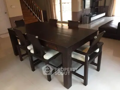 Spacious dining area with elegant wooden table and chairs in modern home