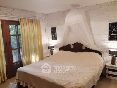 Charming bedroom with rustic decor and canopy bed, featuring white brick walls and warm lighting.