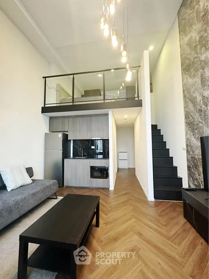 Modern loft apartment with mezzanine, stylish kitchen, and elegant lighting