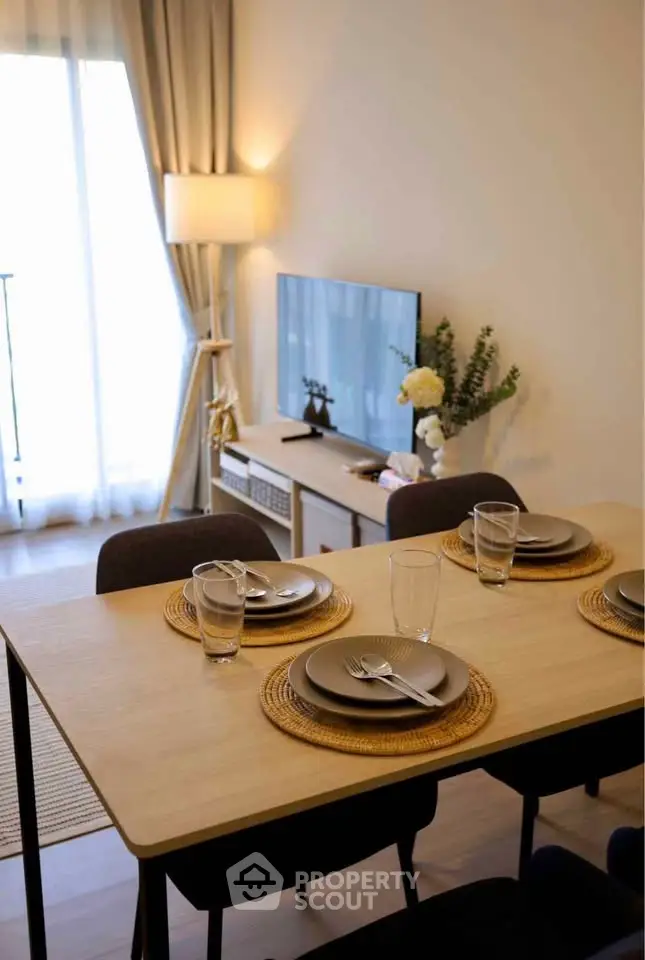 Modern dining area with elegant table setting and cozy living room ambiance
