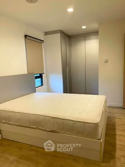 Spacious bedroom with modern wardrobe and natural light