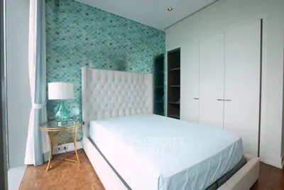 Modern bedroom with stylish headboard and elegant decor in a luxury apartment.