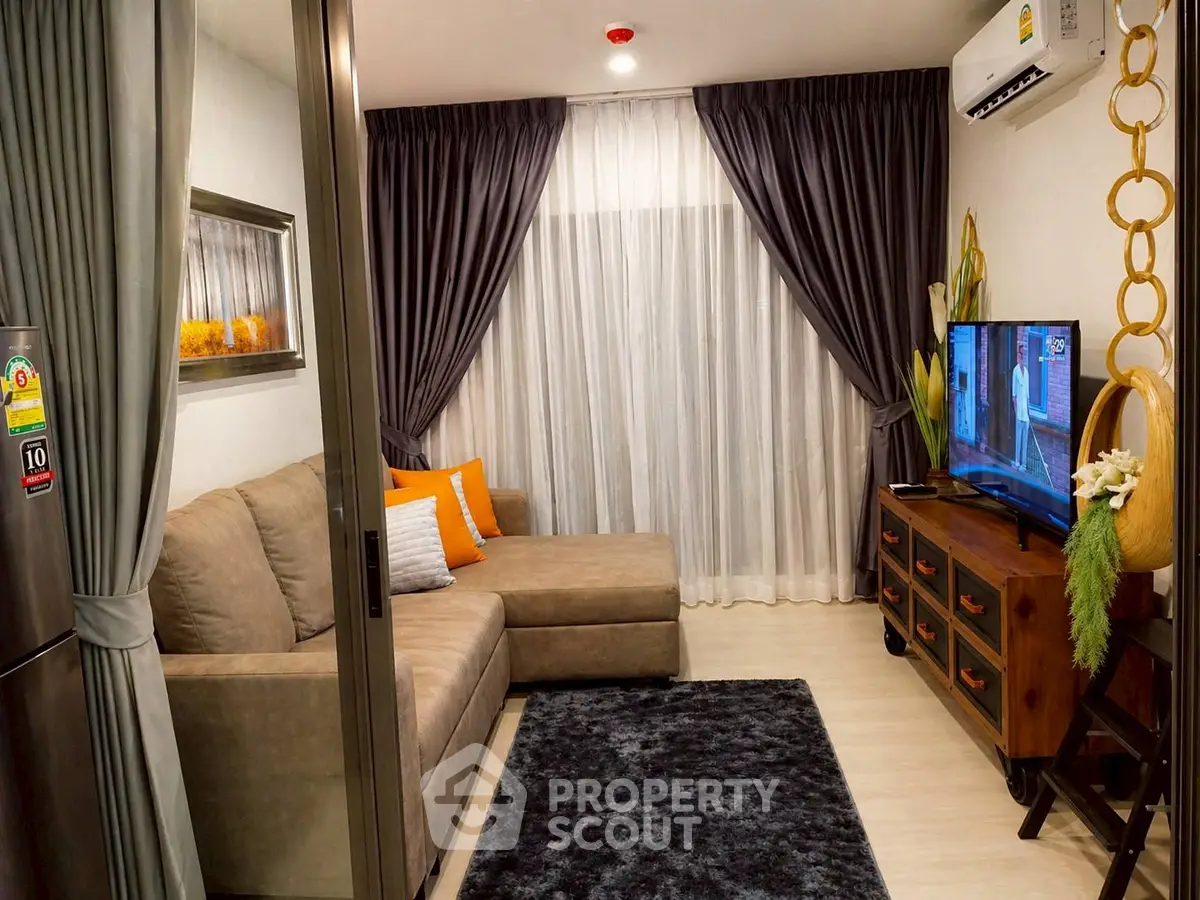 Cozy living room with modern decor, plush sofa, and flat-screen TV, perfect for relaxation.