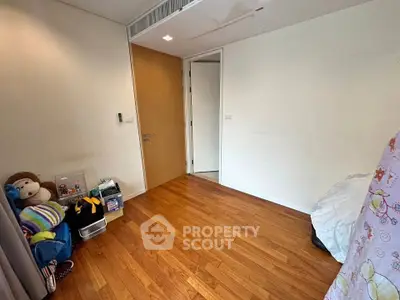 Cozy bedroom with wooden flooring and minimalistic decor