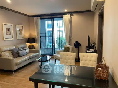 Elegant living room with modern decor and balcony view in a stylish apartment.
