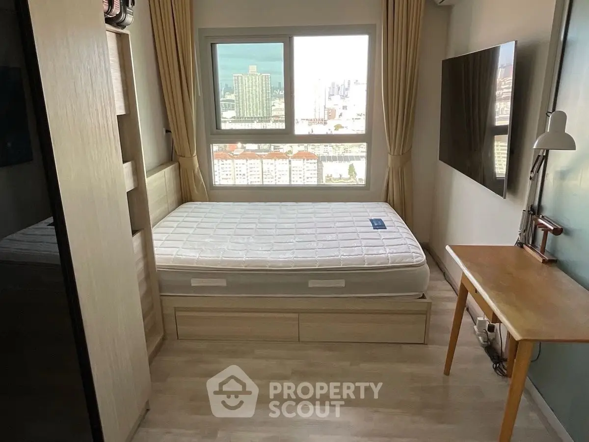 Cozy bedroom with city view, featuring a comfortable bed and modern decor.