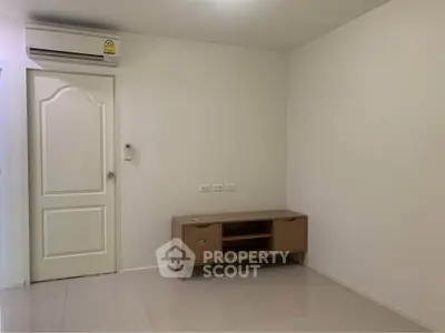 Minimalist living room with air conditioning and modern wooden cabinet.