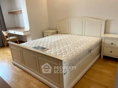 Spacious bedroom with elegant wooden furniture and natural light, perfect for a cozy retreat.