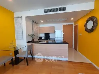 Modern kitchen with vibrant yellow walls and sleek wooden flooring