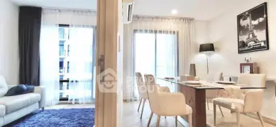 Elegant living and dining area with modern decor and large windows for natural light.