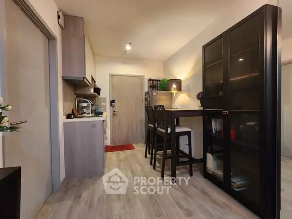 Modern kitchen with dining area and stylish cabinetry in cozy apartment