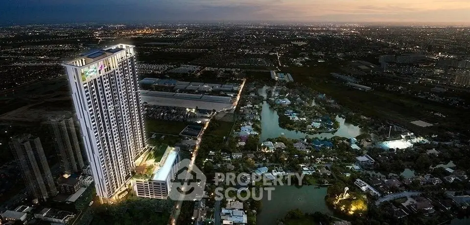 Stunning aerial view of a modern high-rise building with illuminated cityscape at dusk.