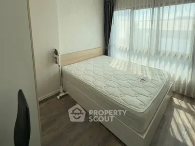 Bright bedroom with large window and modern furnishings