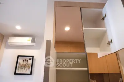 Modern kitchen interior with open cabinets and air conditioning unit