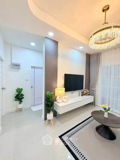 Elegant living room with modern decor, chandelier, and wall-mounted TV, perfect for stylish urban living.