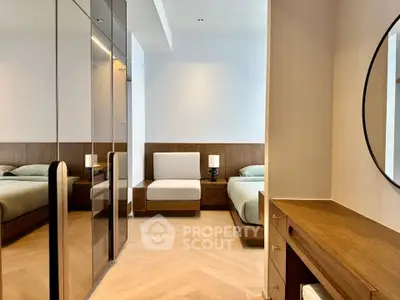 Luxurious bedroom with elegant wood furnishings and mirrored wardrobe
