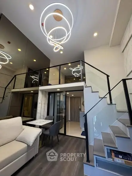 Modern duplex living room with stylish lighting and sleek staircase