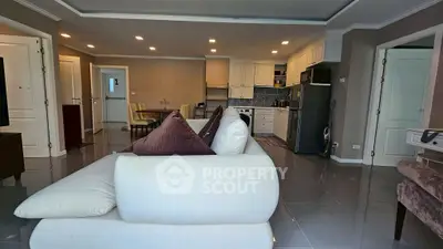 Spacious open-plan living room with modern kitchen and elegant decor