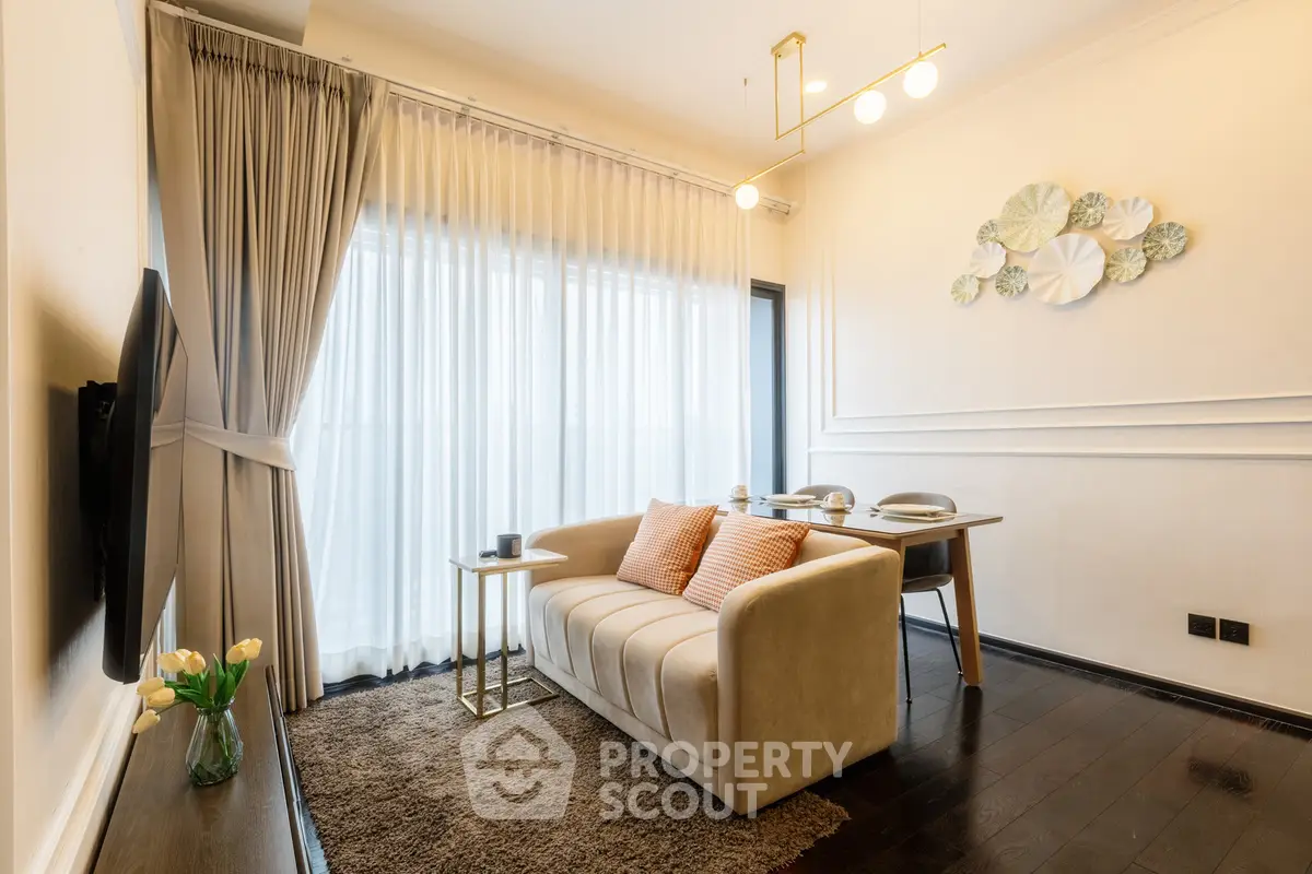 Elegant living room with cozy sofa, dining area, and stylish decor in modern apartment.