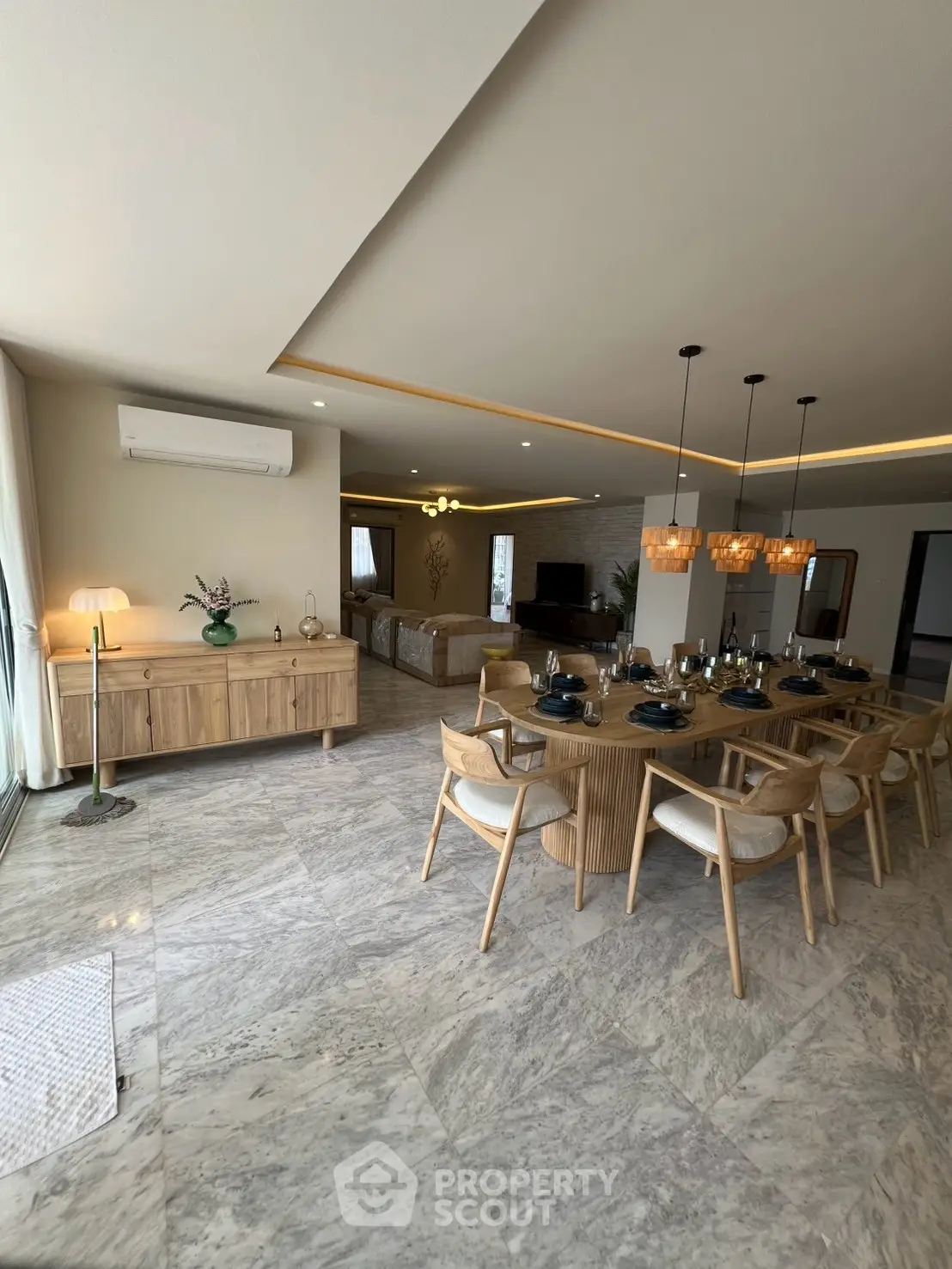 Spacious modern living and dining area with elegant decor and ample natural light.