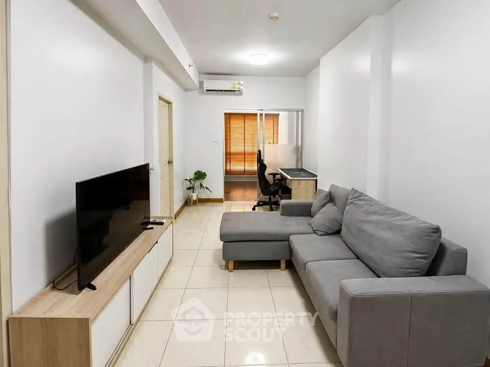 Modern living room with sleek furniture and study area, perfect for urban living.