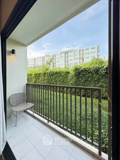 Charming balcony with lush garden view in modern apartment complex