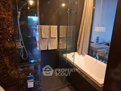Luxurious modern bathroom with glass shower and elegant bathtub