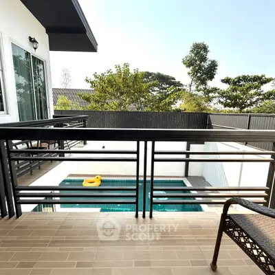 Modern balcony overlooking private pool with lush greenery