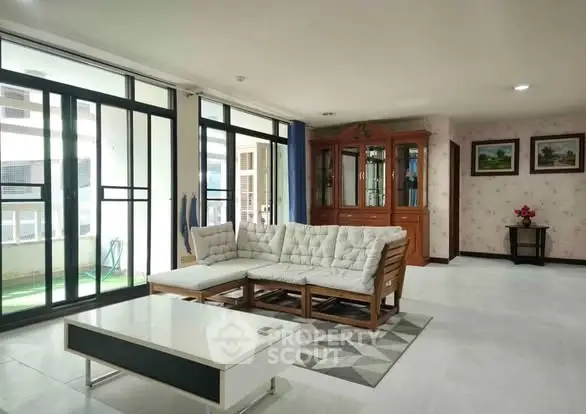 Spacious living room with large windows and elegant furniture