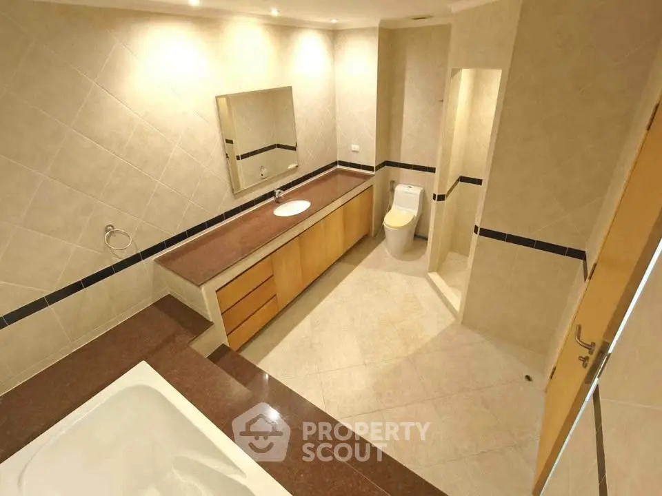 Spacious modern bathroom with elegant fixtures and ample lighting
