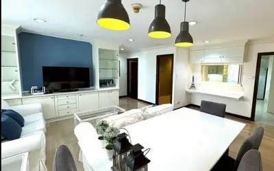 Spacious modern living room with stylish decor and ample natural light.