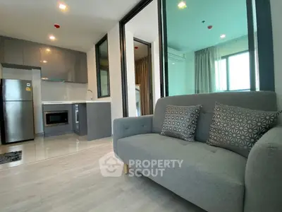 Modern open-layout apartment with sleek kitchen and cozy living area
