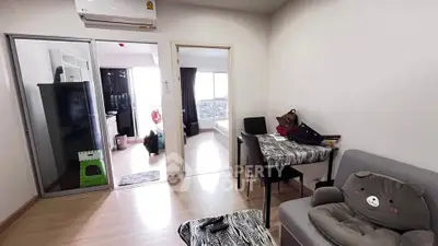 Cozy living room with modern decor and open view to bedroom