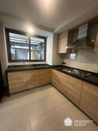 Modern kitchen with sleek wooden cabinets and gas stove