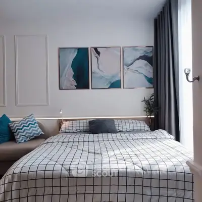 Stylish bedroom with modern decor and cozy bedding in a well-lit space.