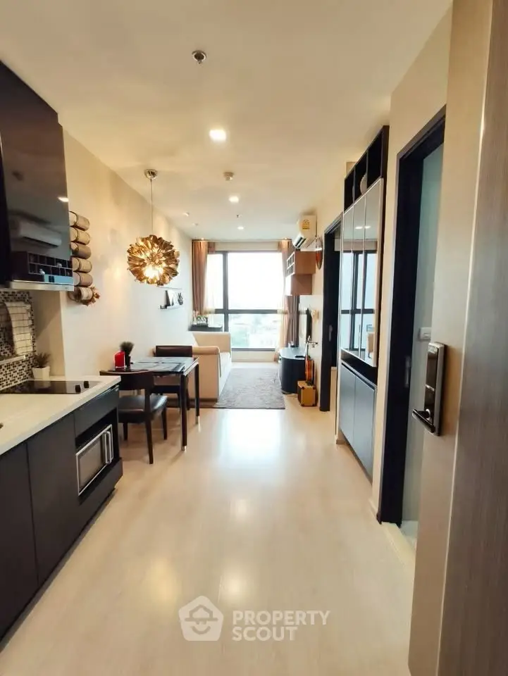 Modern open-plan living room with stylish decor and large window view.