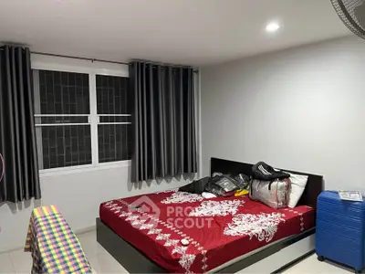 Cozy bedroom with modern decor and ample natural light