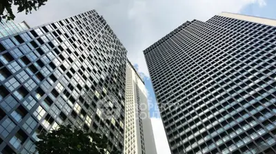 Stunning view of modern high-rise buildings with reflective glass facades against a blue sky.