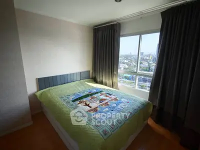 Cozy bedroom with large window offering stunning city views, featuring a comfortable bed and elegant curtains.