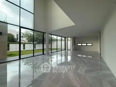 Spacious modern living room with floor-to-ceiling windows and glossy marble floors.